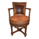 Antique swivel armchair in carved wood and patinated leather – neo-Renaissance style