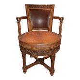 Antique swivel armchair in carved wood and patinated leather – neo-Renaissance style