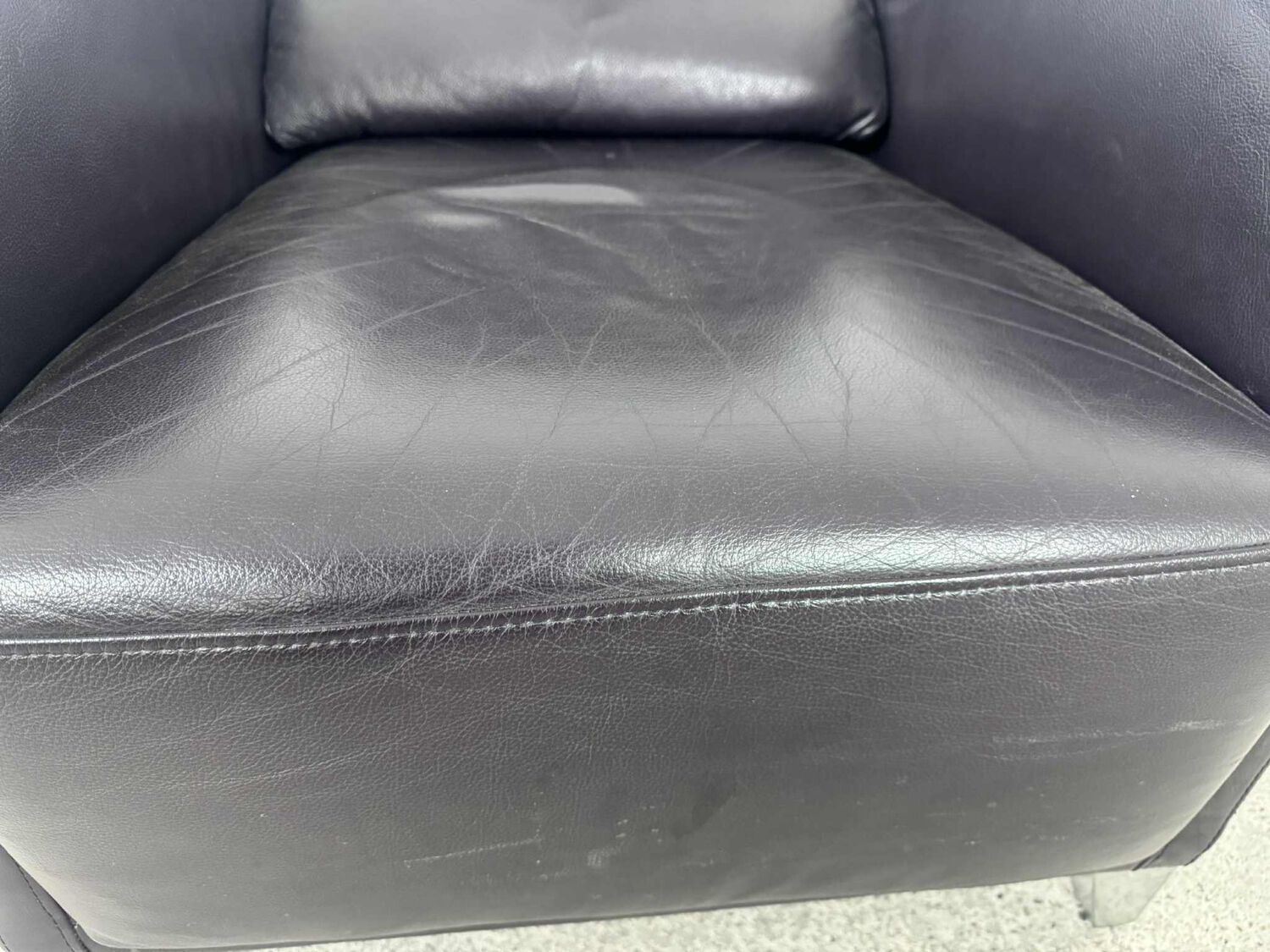 Pair of aubergine leather club armchairs by Cinna.