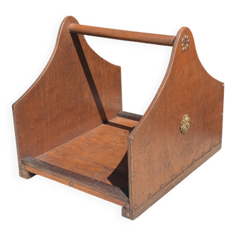Old wooden log holder with metal ornaments