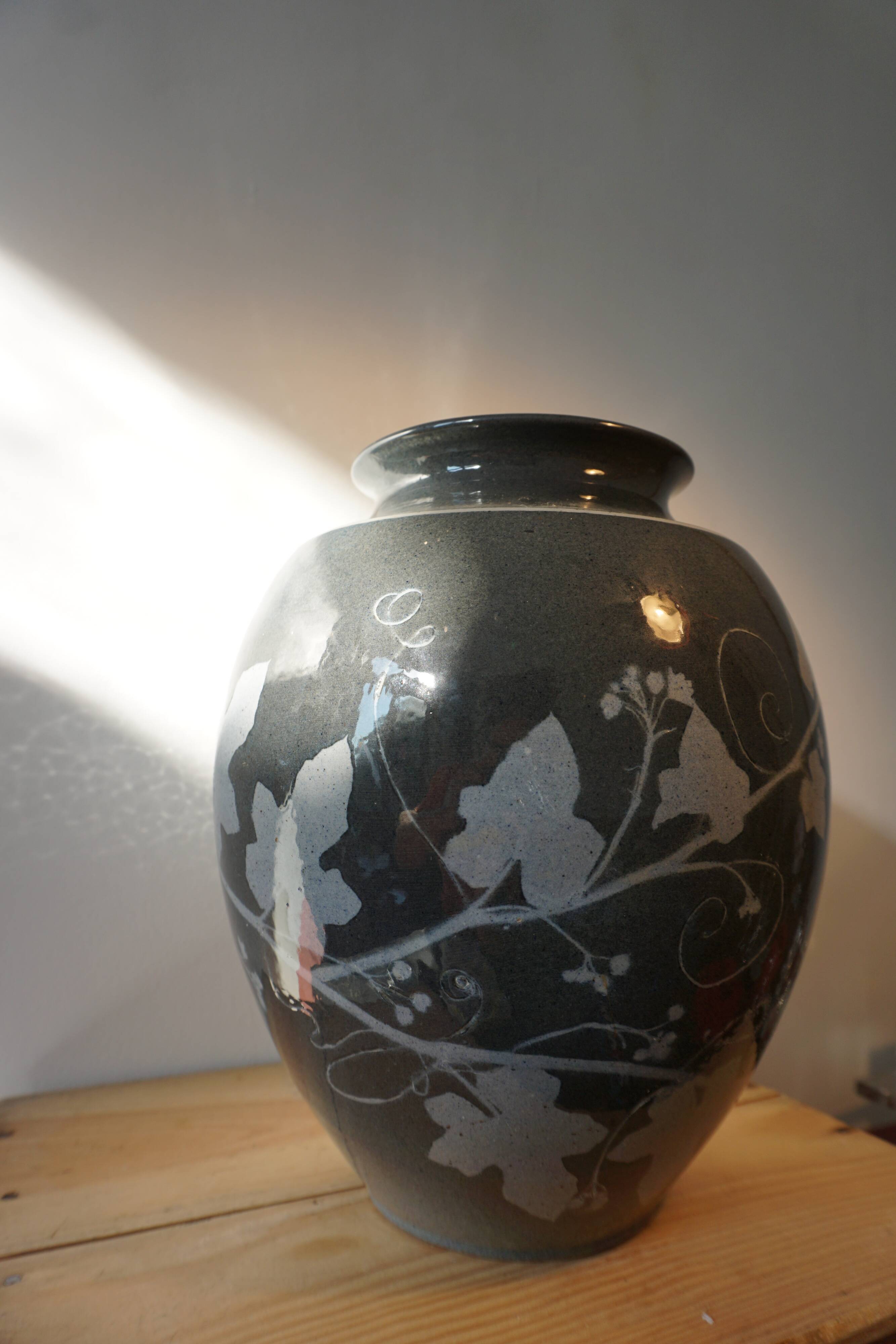 Black vase with plant decoration by Philippe Jacques