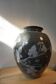 Black vase with plant decoration by Philippe Jacques