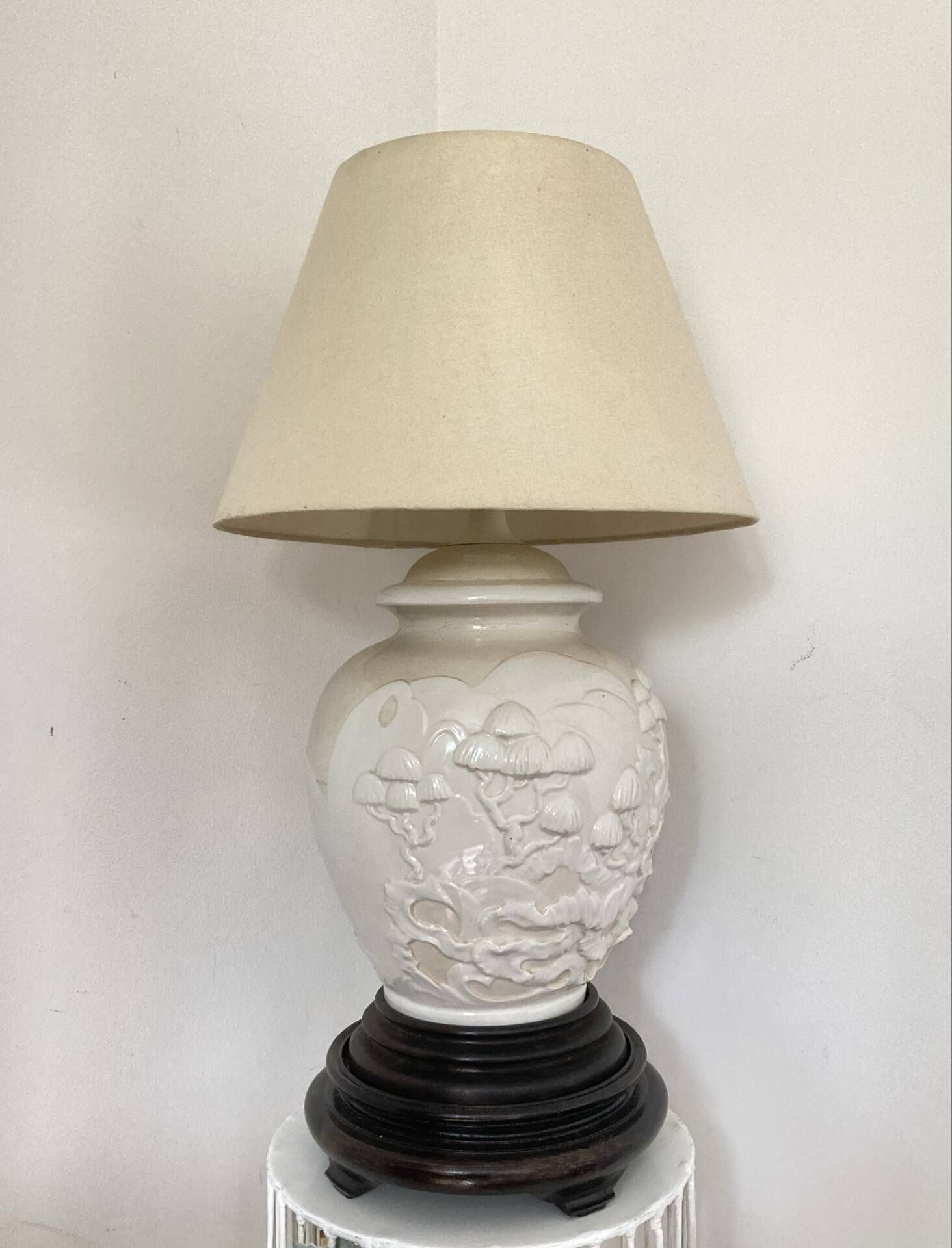 1980s ceramic table lamp with a wooden base and adjustable shade.
