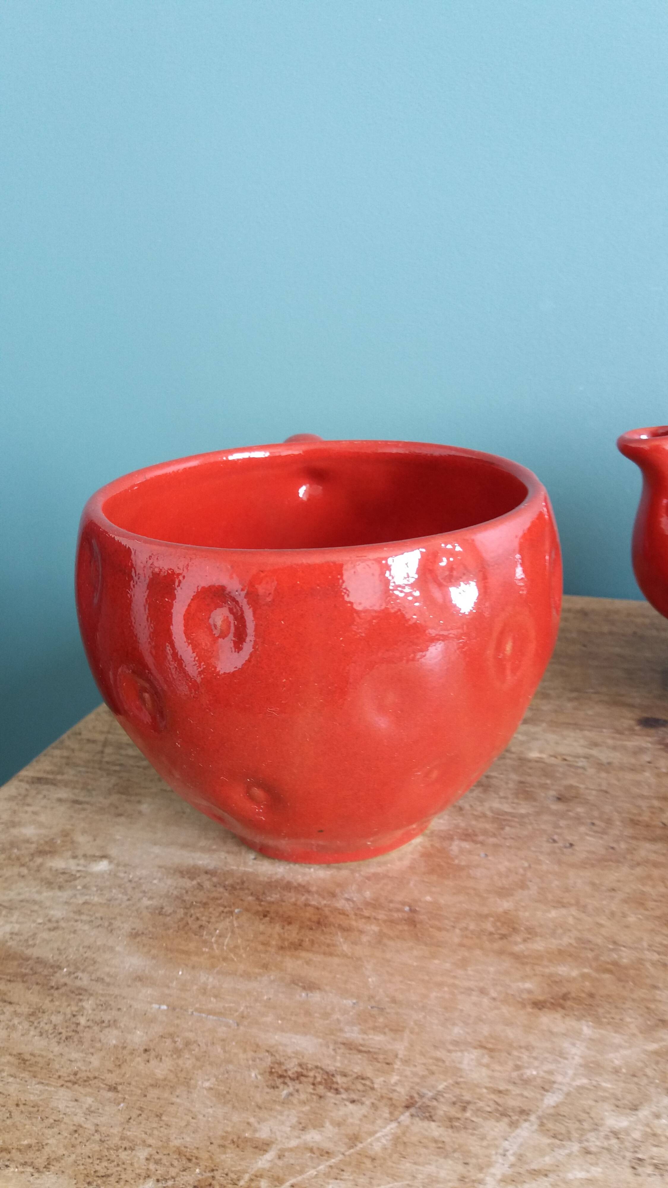 Teapot and cup in the shape of a strawberry.