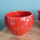 Teapot and cup in the shape of a strawberry.