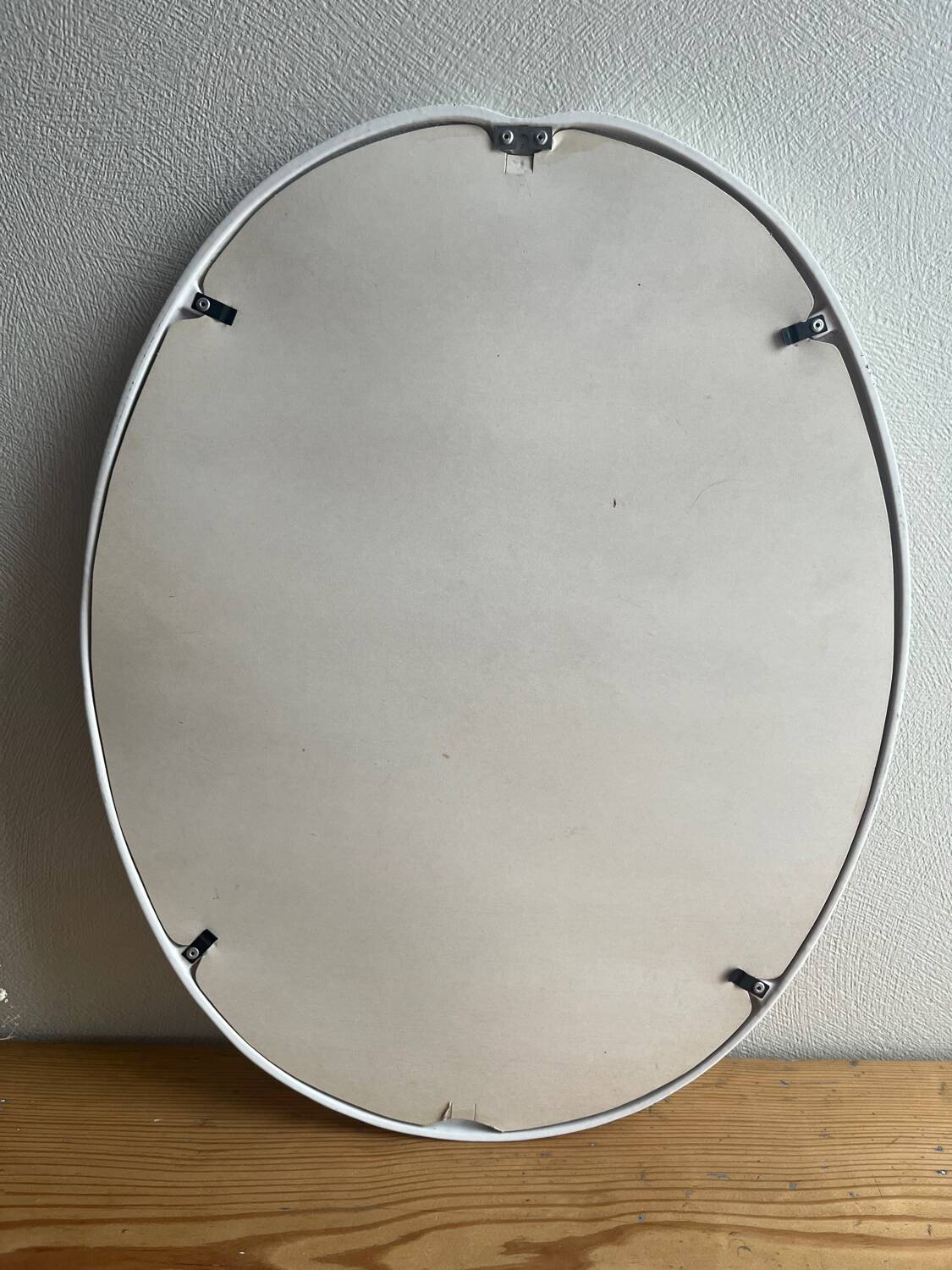 Vintage oval mirror in white enamelled cast iron