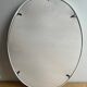 Vintage oval mirror in white enamelled cast iron