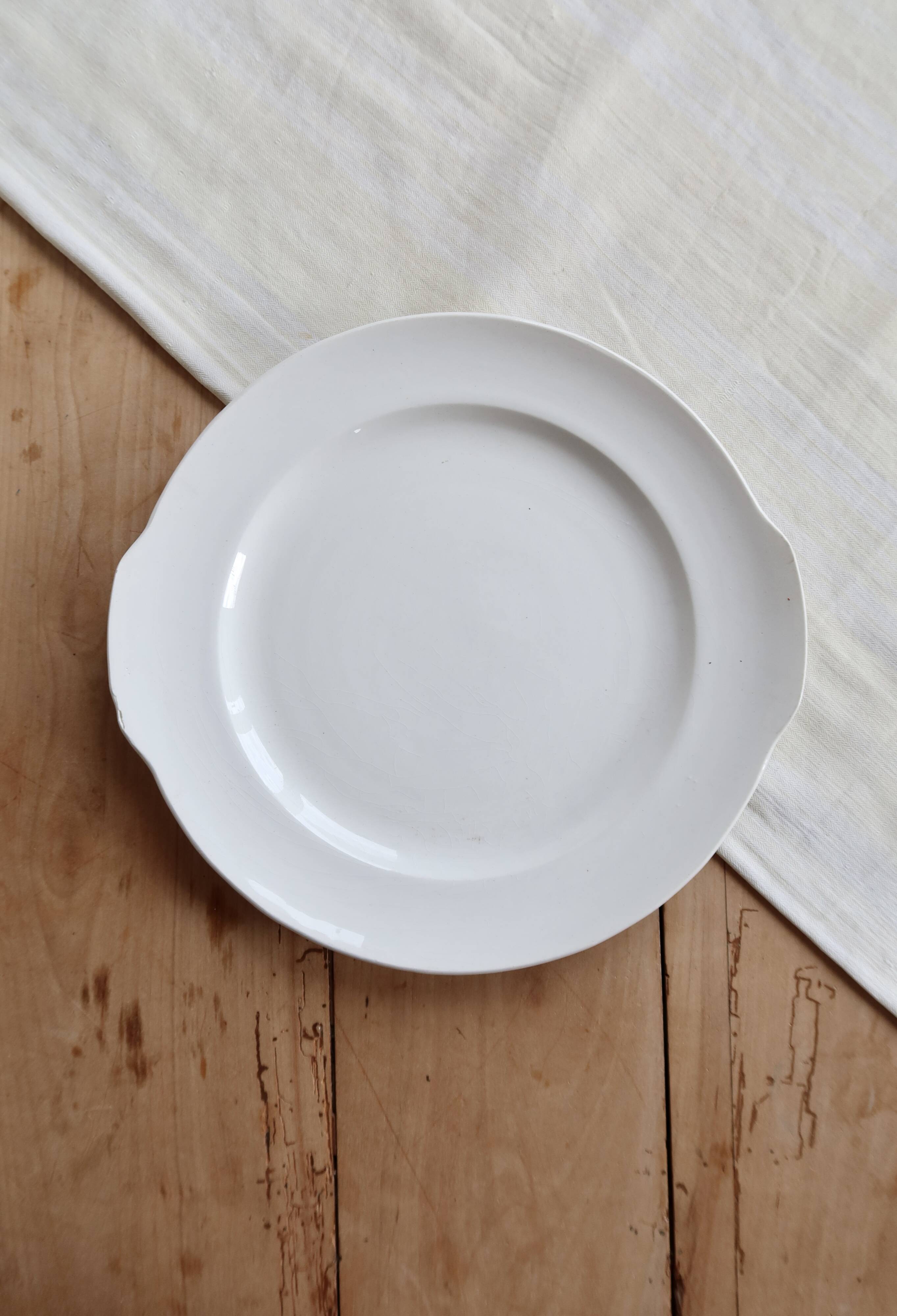 Vintage round white porcelain serving dish with handles.