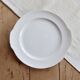 Vintage round white porcelain serving dish with handles.