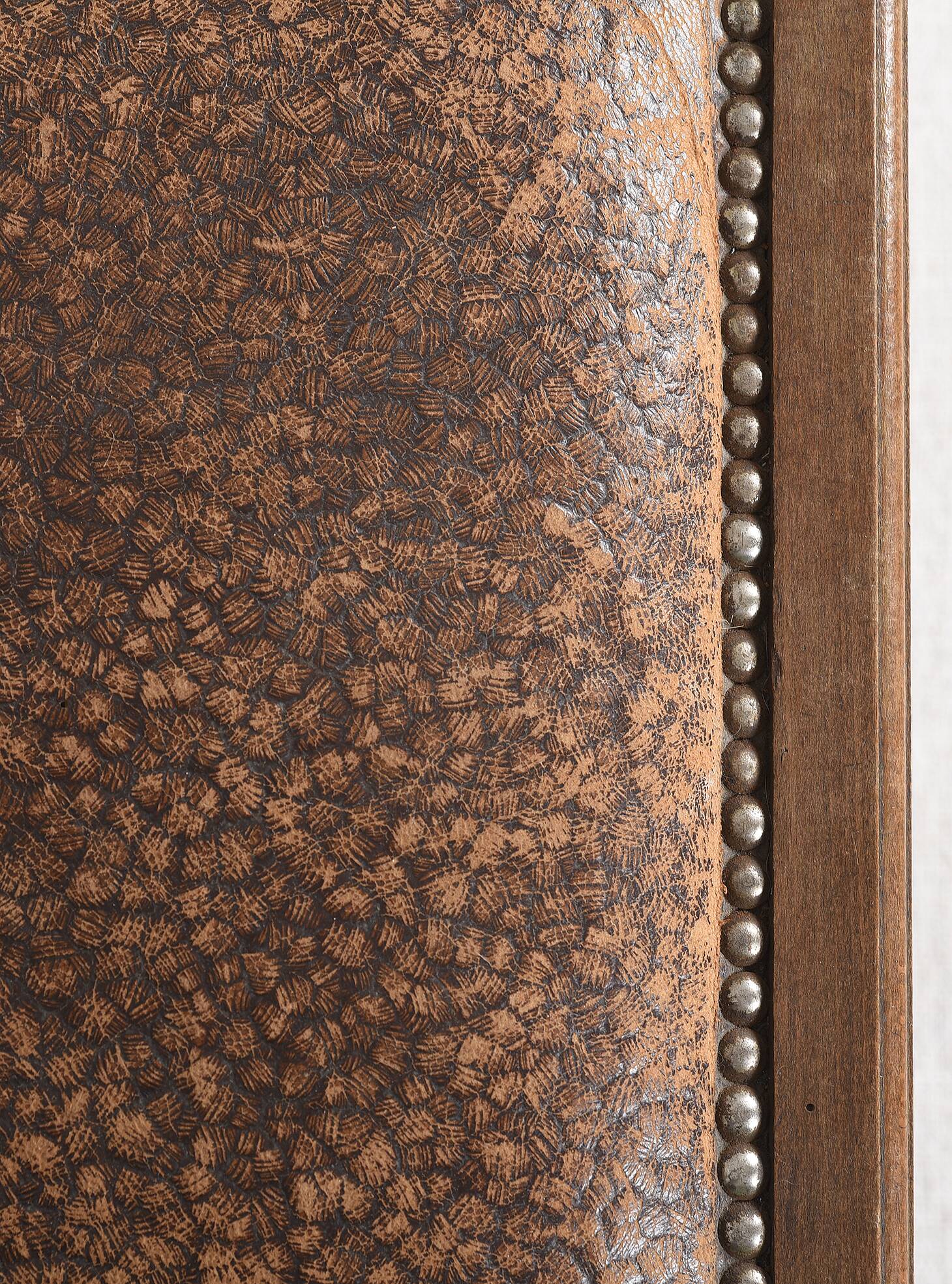 Art Deco style chair in carved wood and leather.