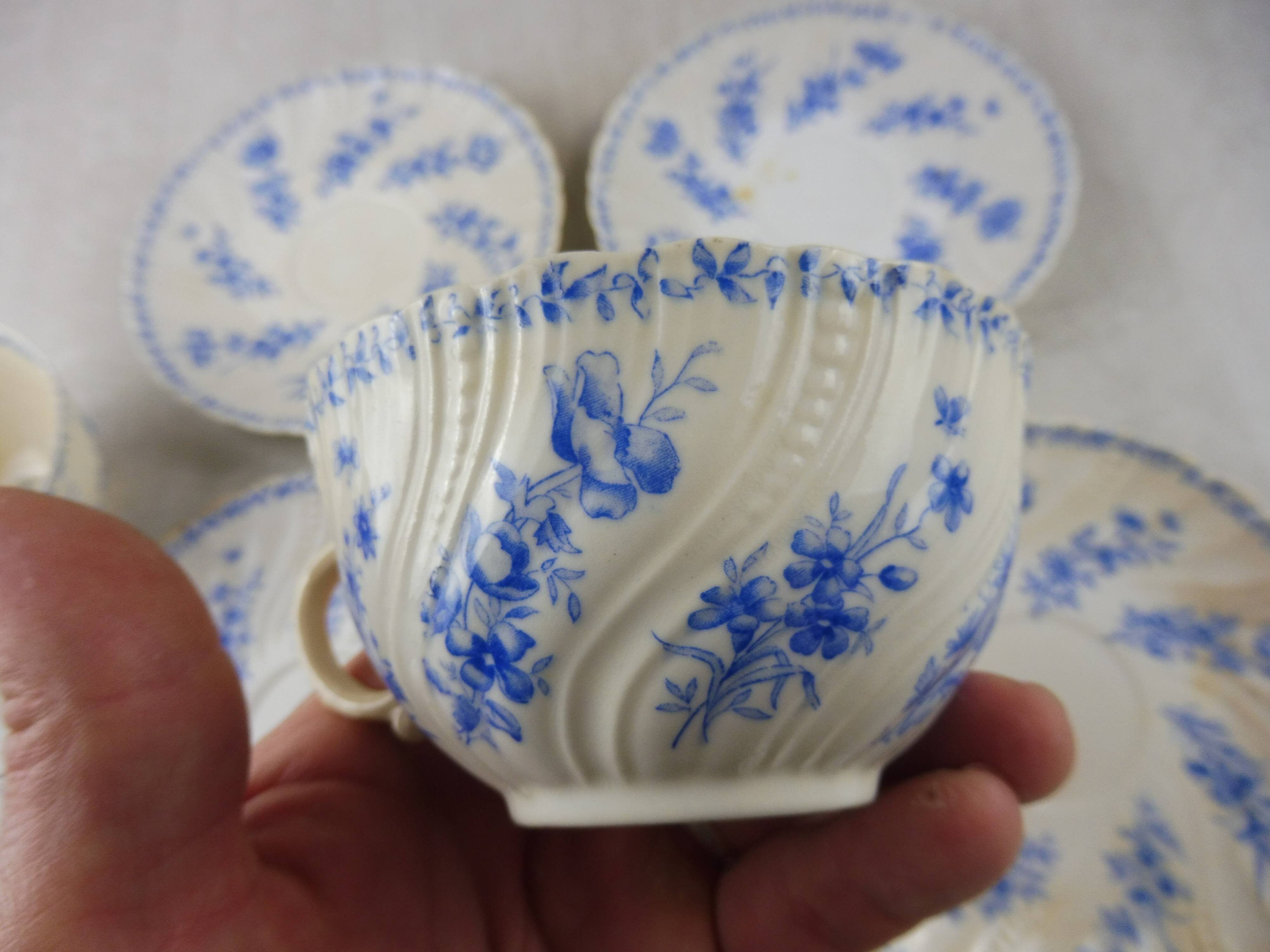 Lot of porcelain cups and under cups, twisted decoration, from Sarreguemines