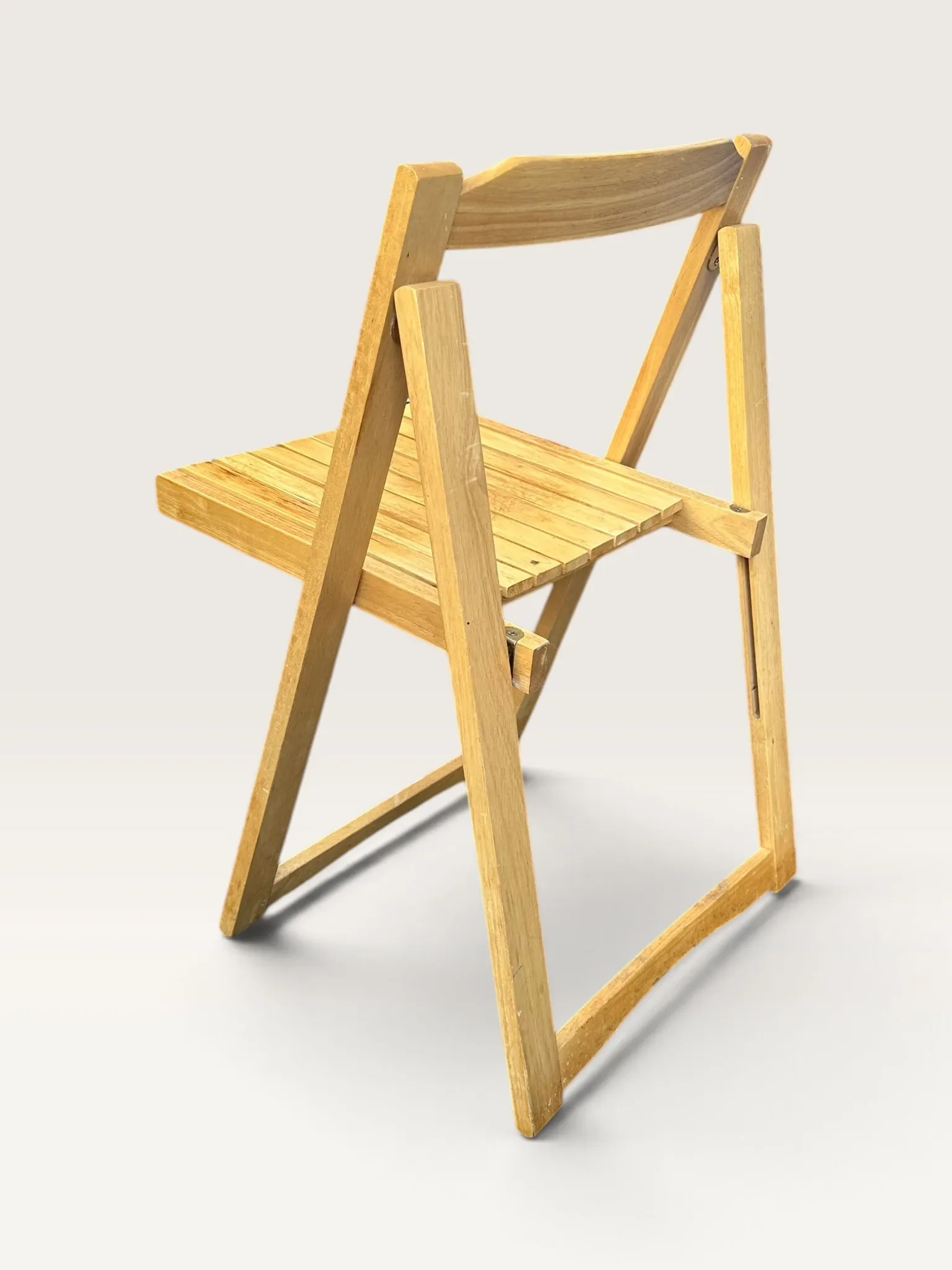 Blonde wooden folding chair in the style of Aldo Jacober.