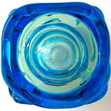Blown blue glass bottle with inclusions