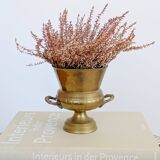 Vintage brass cache-pot on a stand with handles, classic decor.