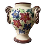Ceramic vase with hand-painted floral decoration.