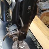 Old Singer sewing machine on pedestal