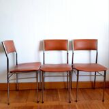 Three mid-century chairs in faux leather and chrome from the 1950s.