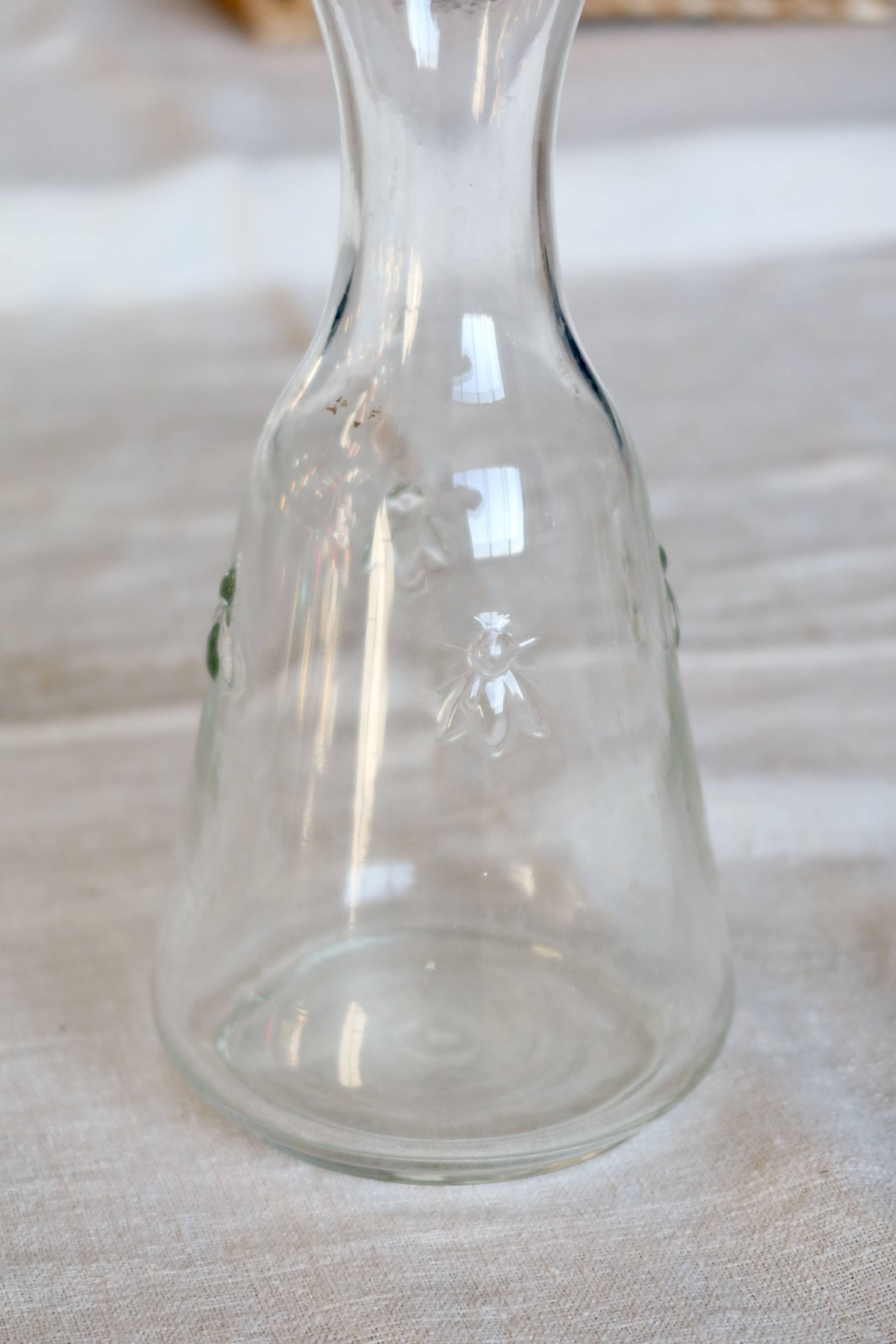 Vintage glass carafe with embossed bee motifs