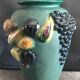 Green ceramic vase with polychrome decoration of fruits and vegetables in relief 33.5 cm