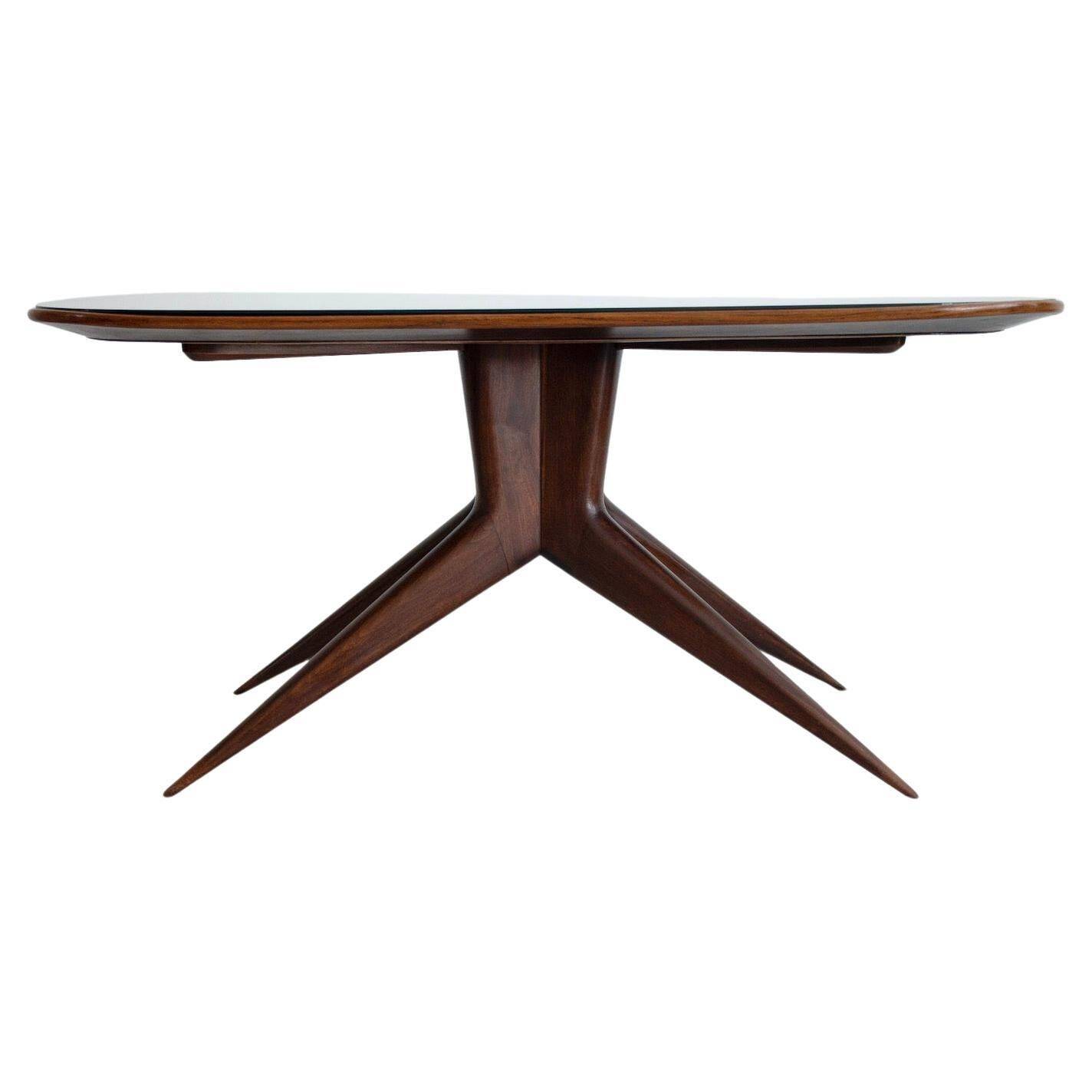 Dining table with a wooden frame and tinted glass top.