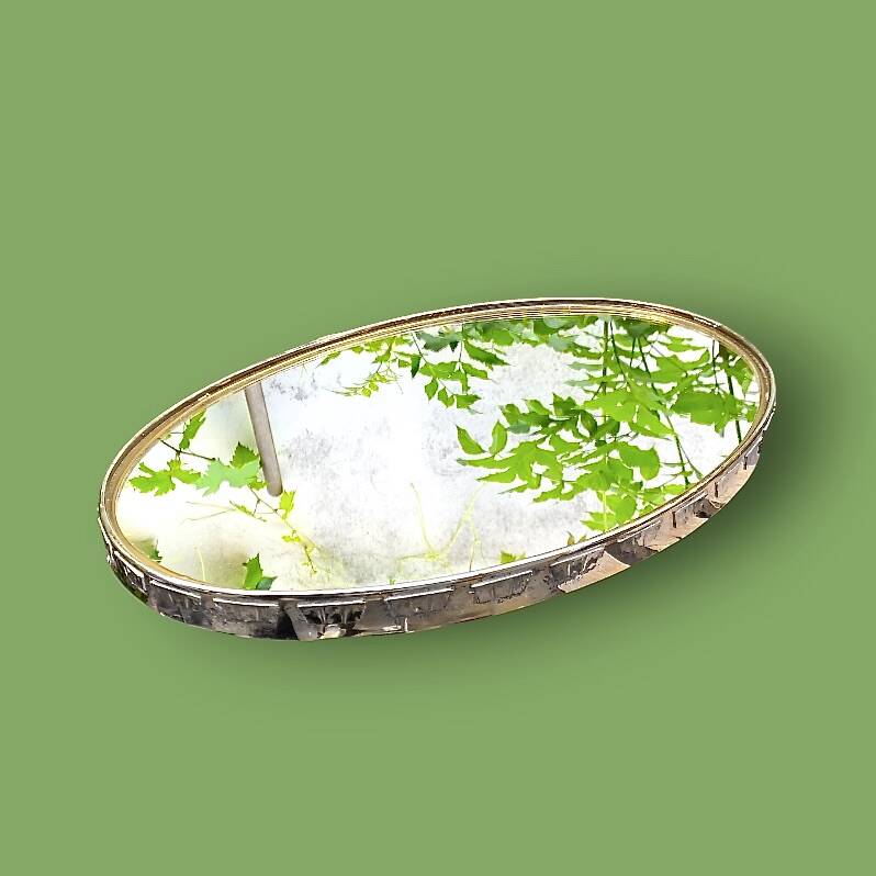 Large antique oval wall mirror in stylized gilt metal, – Hollywood Regency