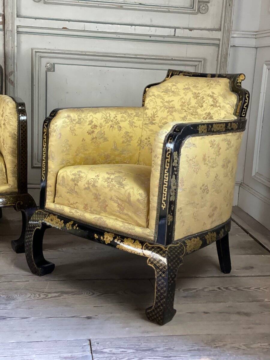 A set of two armchairs, a sofa and two poufs in lacquered wood with gilded chinoiserie decoration.