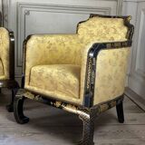 A set of two armchairs, a sofa and two poufs in lacquered wood with gilded chinoiserie decoration.