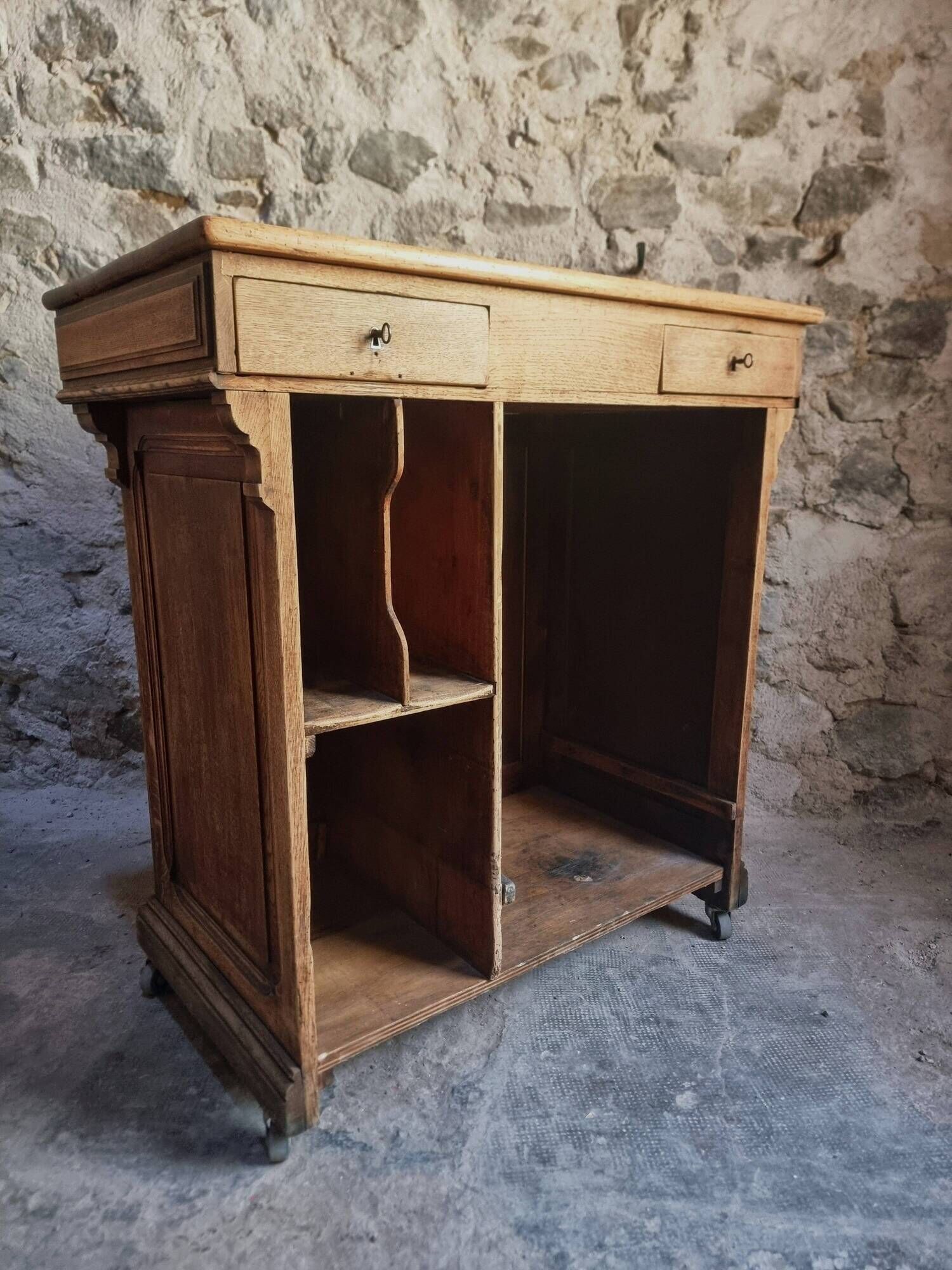 Antique French oak shop counter, kitchen island on wheels, circa 1880–1900.