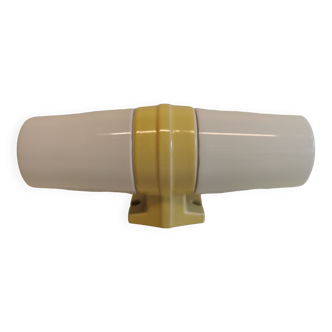 Old bathroom lamp with yellow ceramic base, porcelain sockets and milky white glass