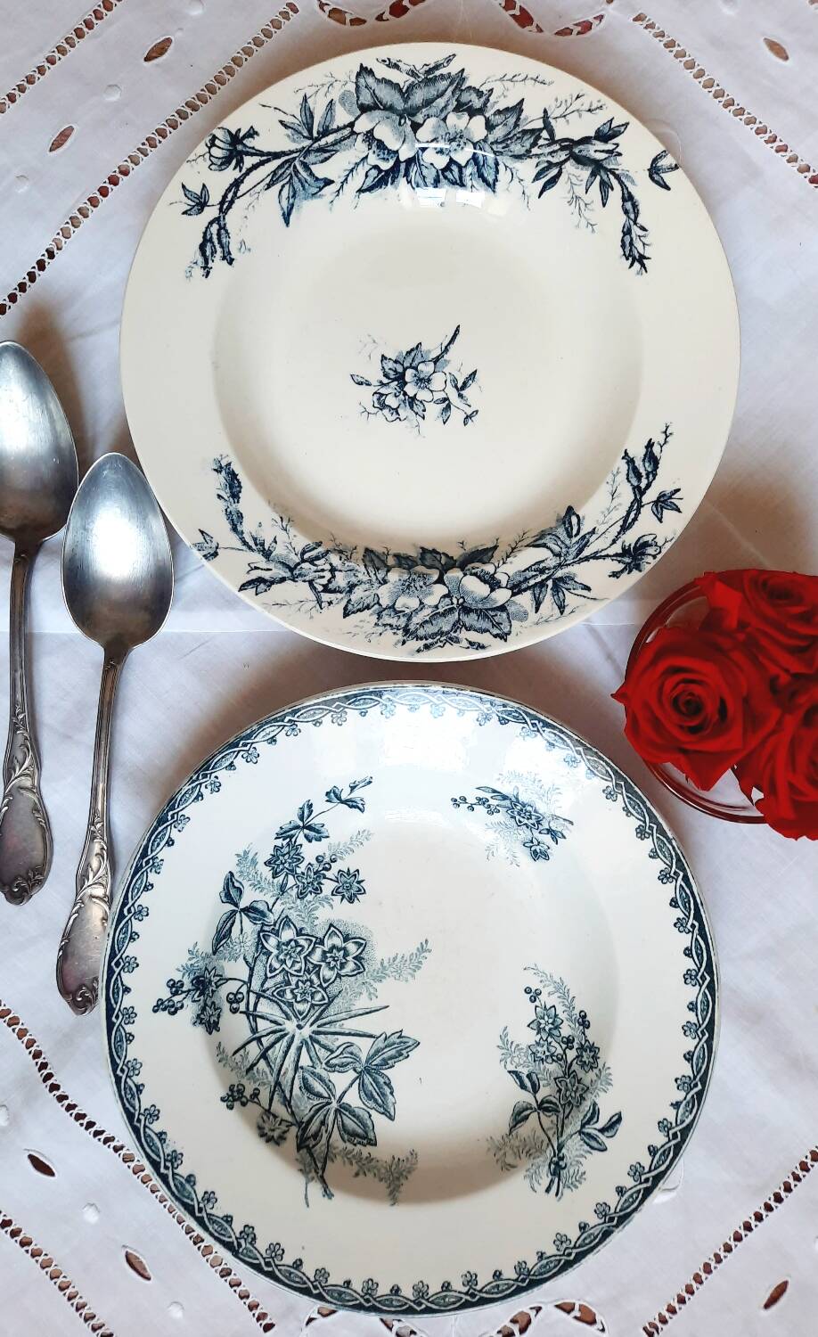 Old mismatched hollow plates in iron earth earthenware accompanied by a soup tureen
