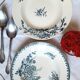 Old mismatched hollow plates in iron earth earthenware accompanied by a soup tureen
