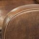Set of a sheepskin armchair and ottoman finished with matching piping