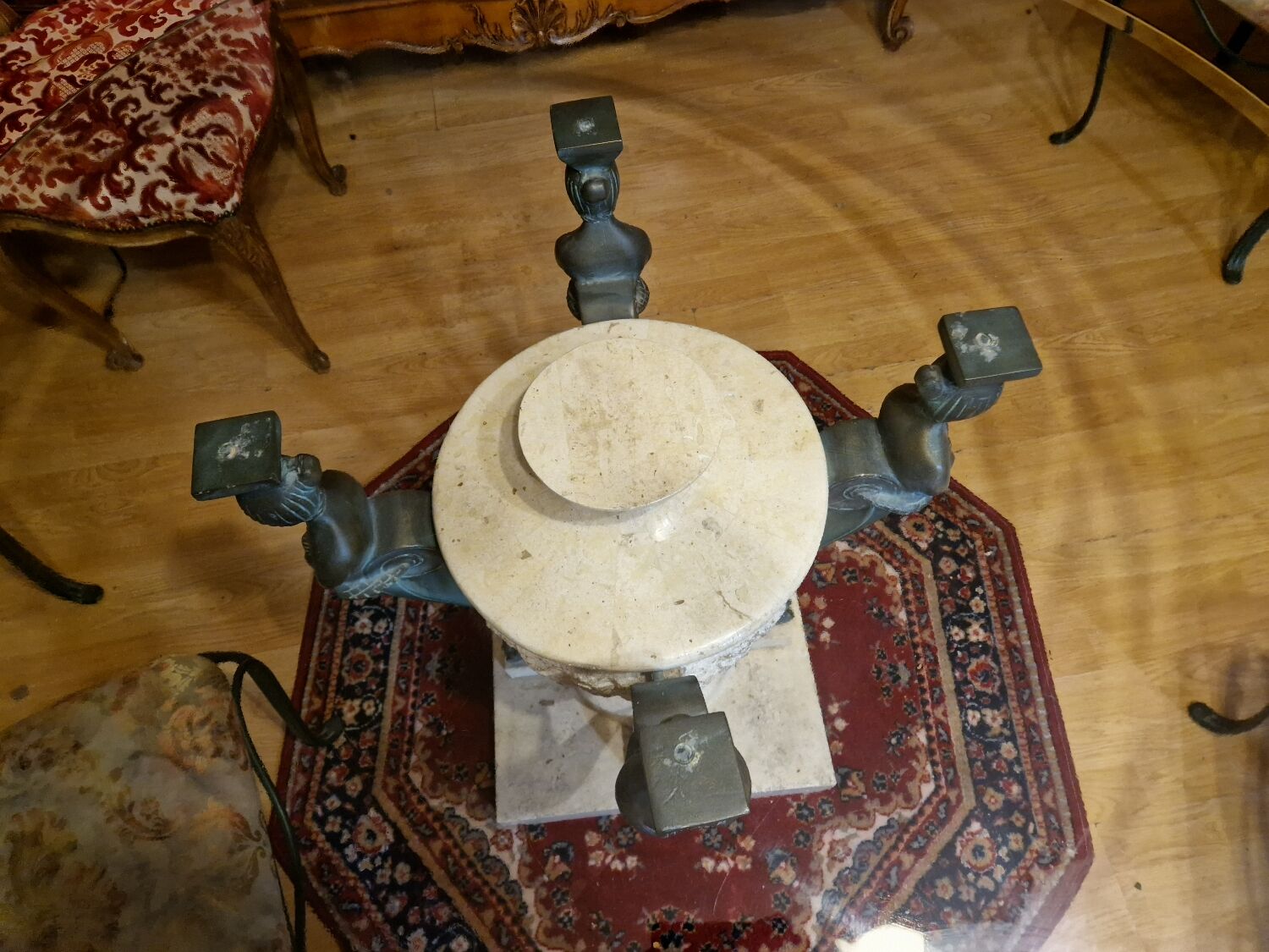 Stone and bronze dining table with ribbed glass top