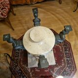 Stone and bronze dining table with ribbed glass top