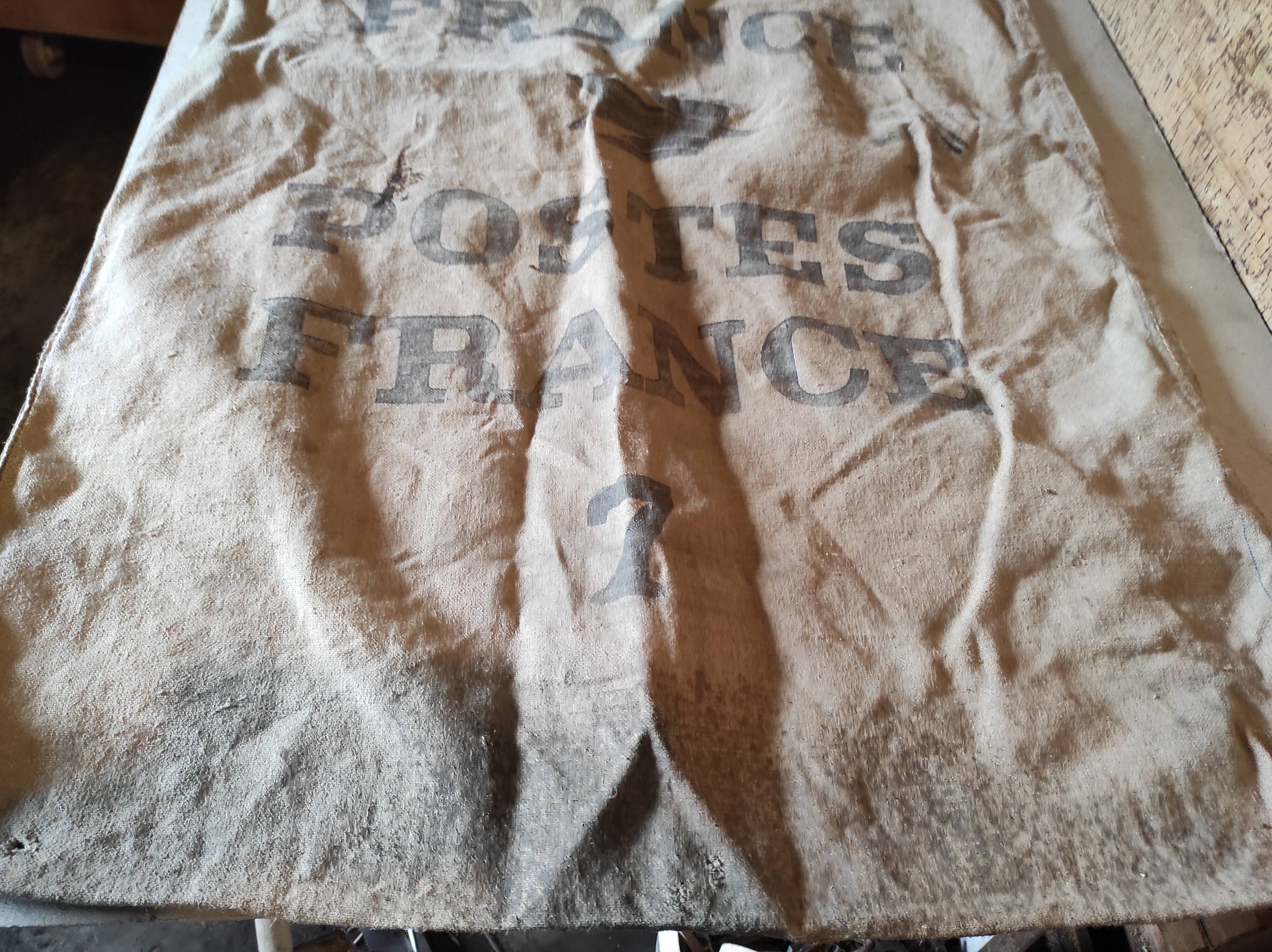 Vintage postal bag trade object of La Poste in mixed-race canvas burlap