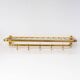 Wall-mounted coat rack with a golden aluminium shelf c. 1960 (62.5 cm)