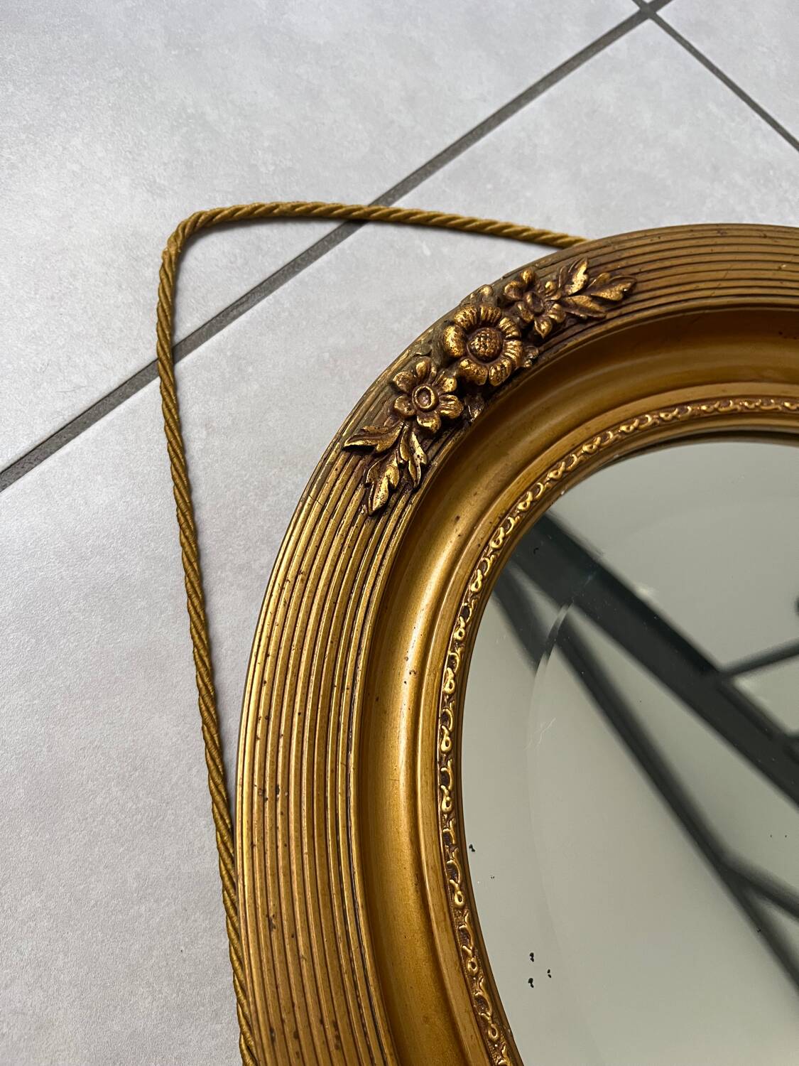 Oval gilt mirror and Art Deco trim