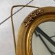 Oval gilt mirror and Art Deco trim