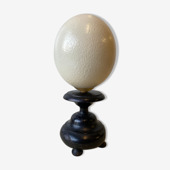 Ostrich egg on blackened wooden base