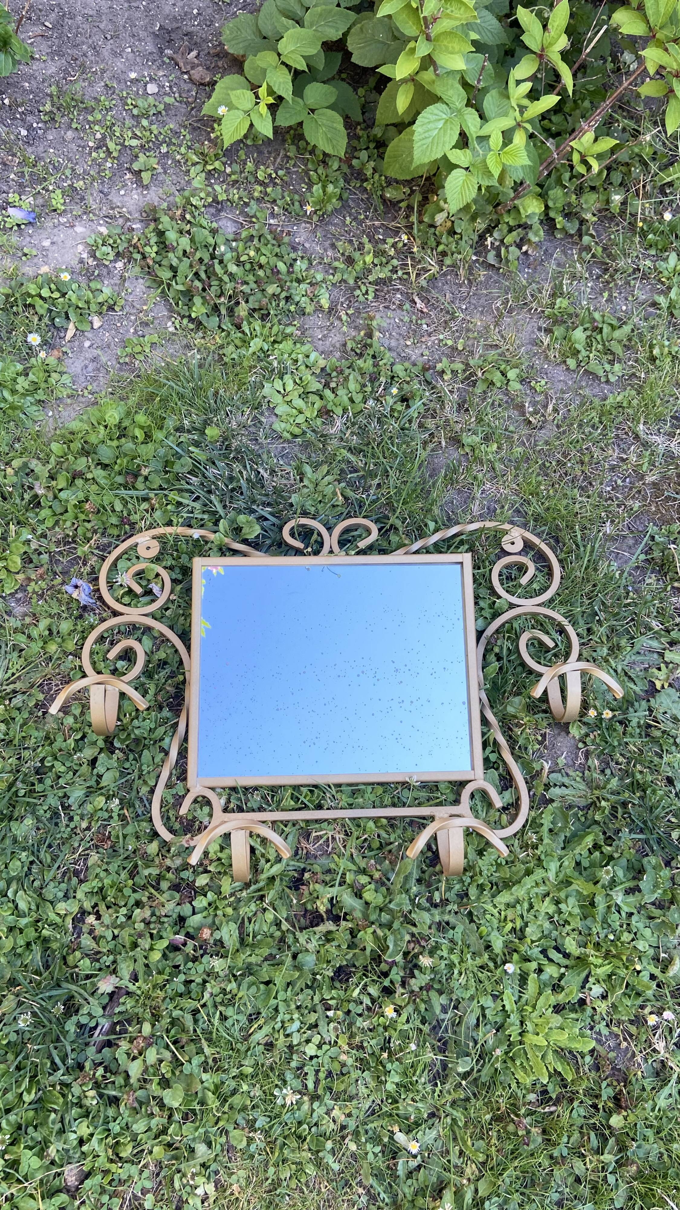 Wall-mounted gilded wrought iron coat rack with mirror