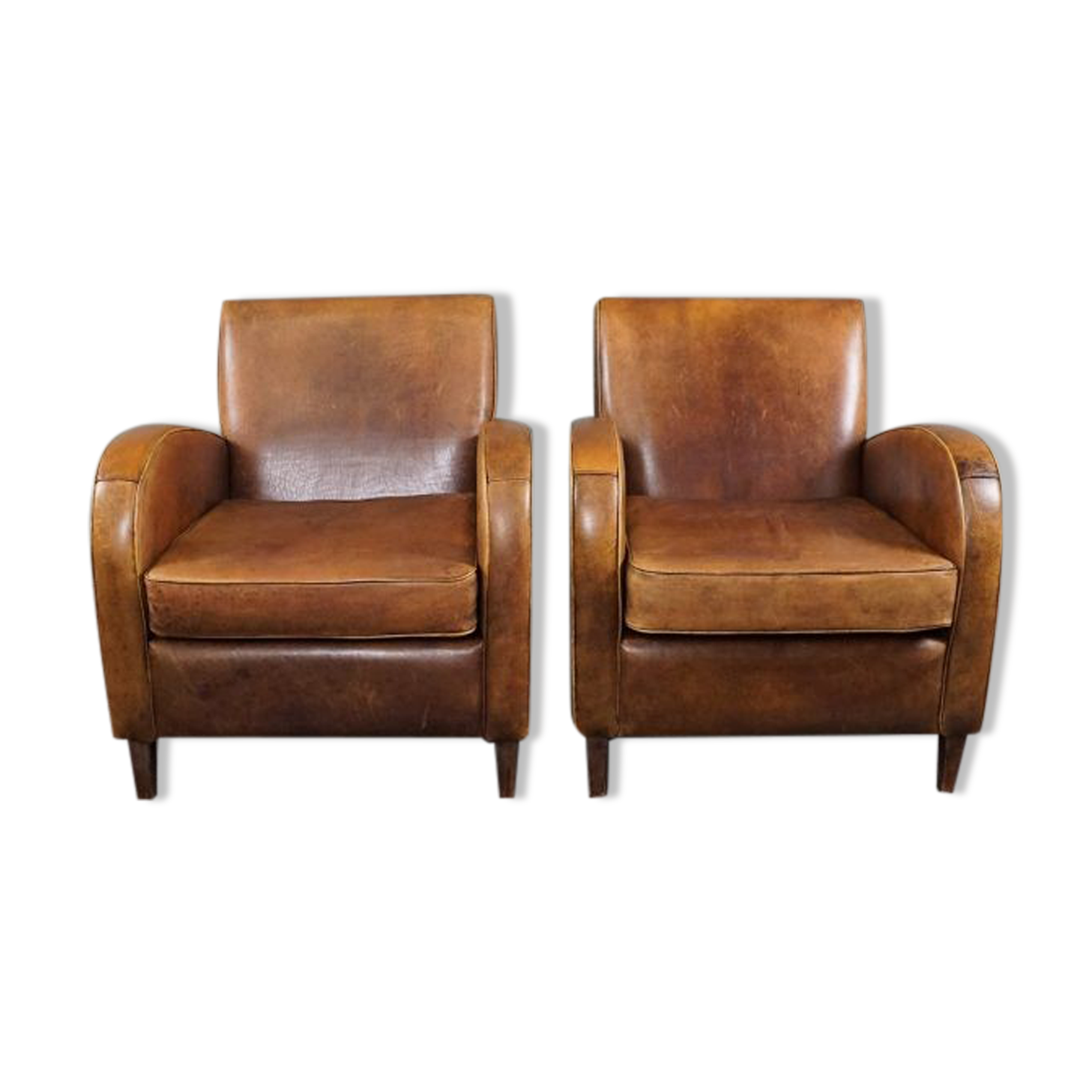 Paire de fauteuils en cuir de mouton