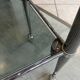 Serving dessert trolley with 2 smoked glass shelves and metal structure.