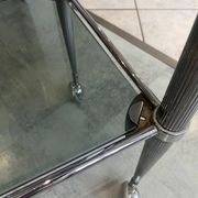 Serving dessert trolley with 2 smoked glass shelves and metal structure.