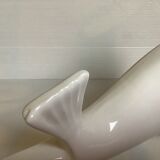 White earthenware sea lion in piggy bank
