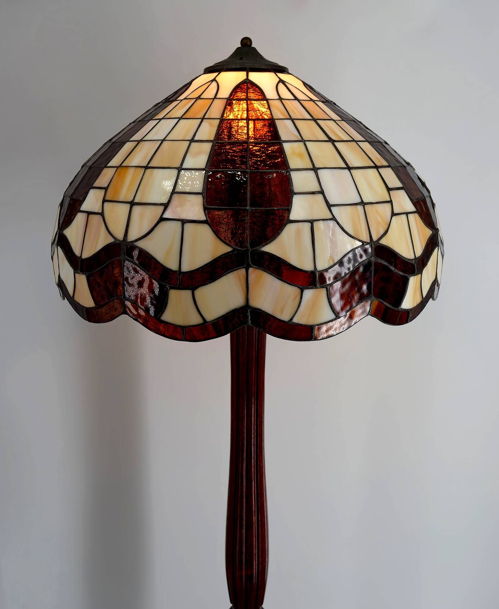Art Deco floor lamp in carved walnut, stained glass shade, France, c. 1920
