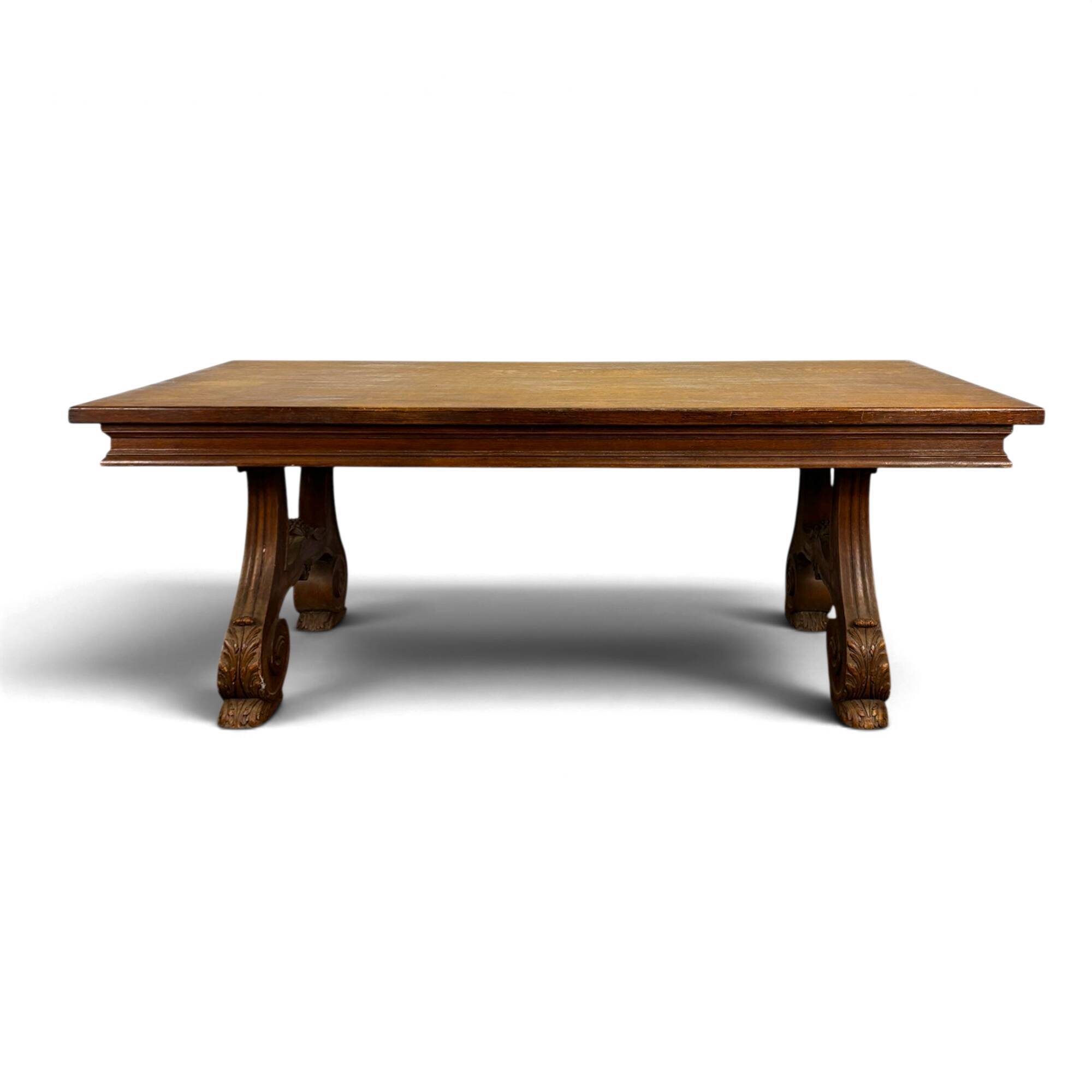 Renaissance-style oak dining table with lyre legs.
