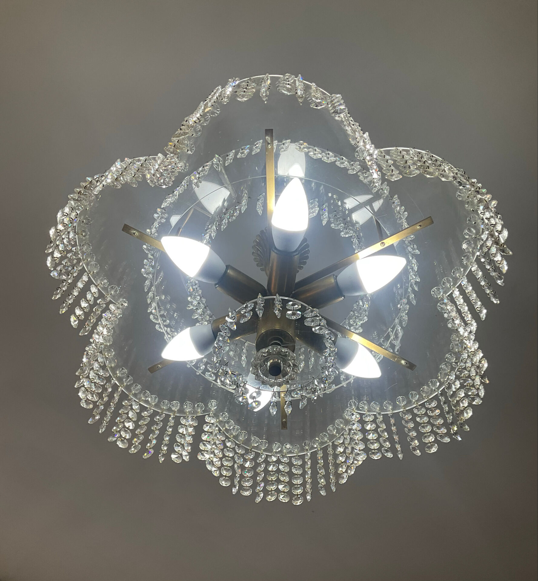 Vintage lucite chandelier with a cascade of crystal pendants from the 1970s.