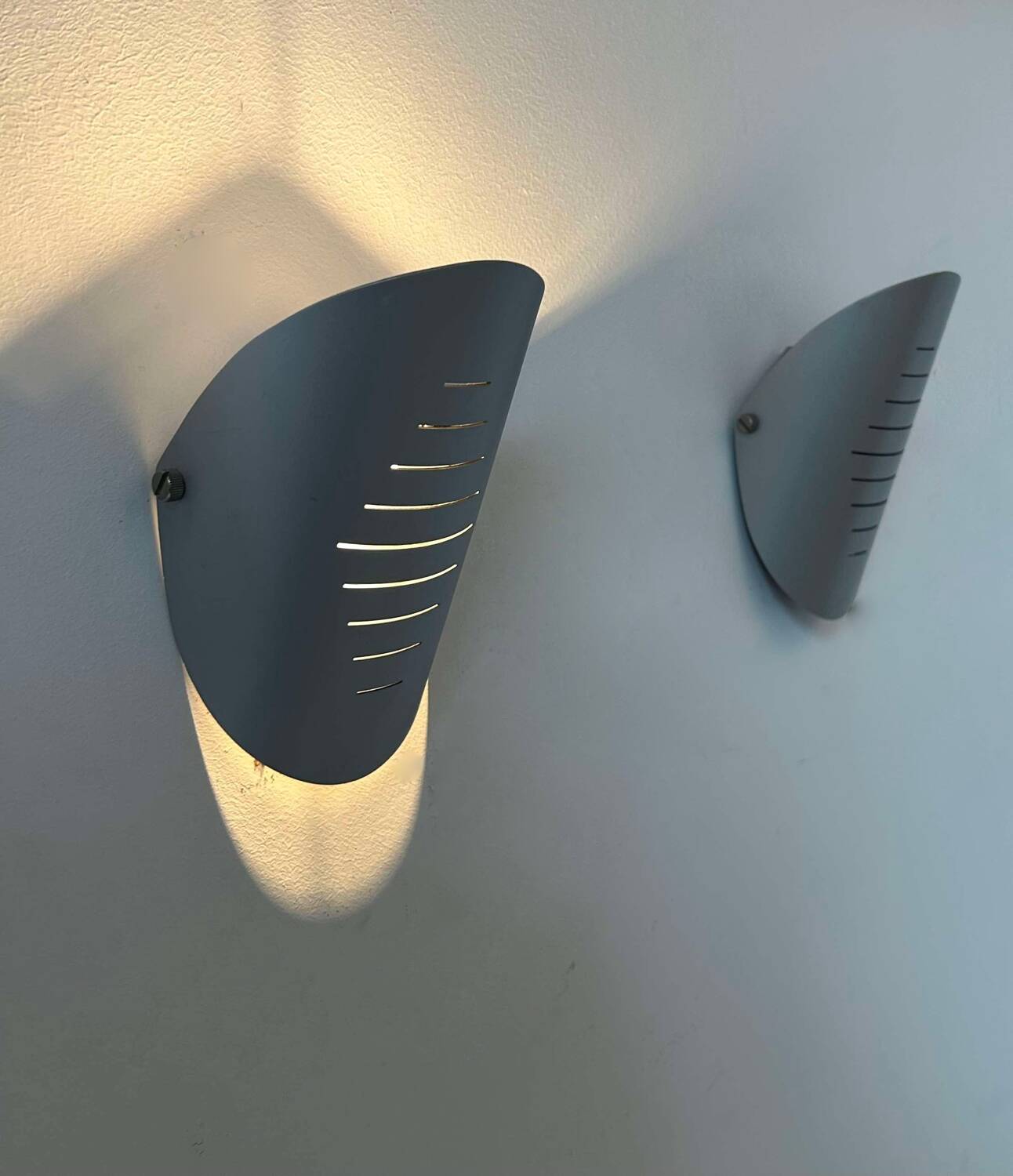 Pair of vintage adjustable wall lights, curved striated metal, France 1980