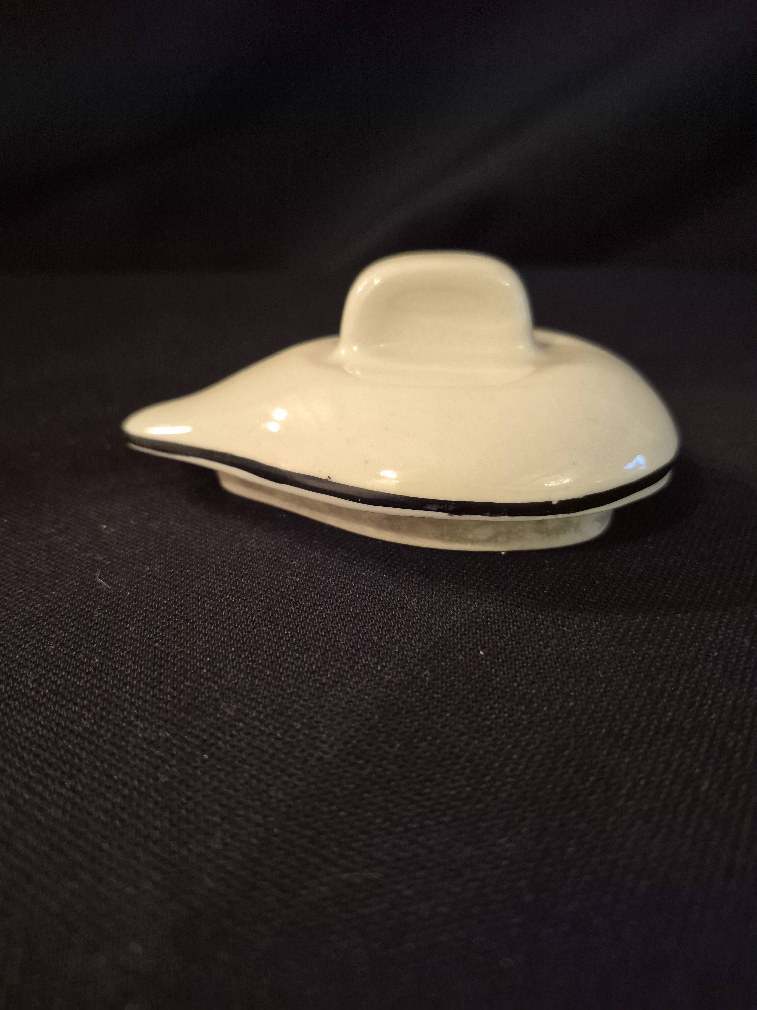 Vintage vase, geometric frieze and flowers with a black border.