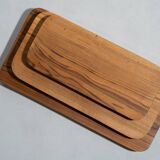 Trio of rounded rectangular trays or cups in monoxyl teak L:35